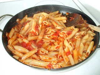 Penne and tomatoes in a pan