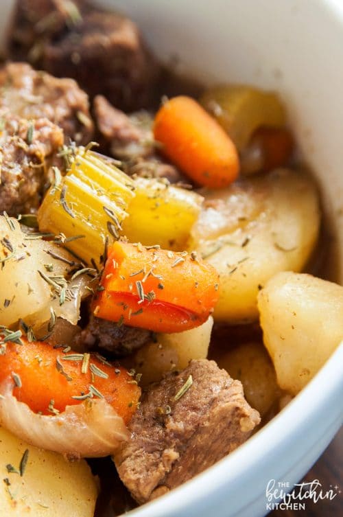 A close up of cooked carrots, celery and the rest of the beef stew cooked in the slow cooker.