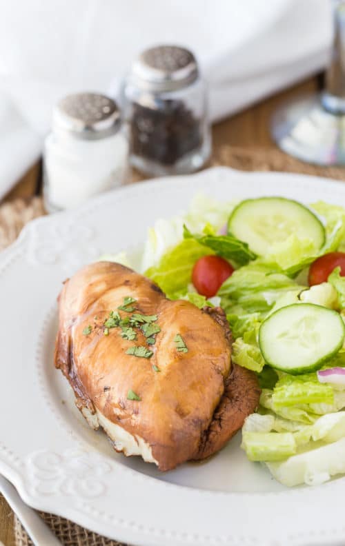 Chicken breast on a beauty plate with a garden salad on the side.