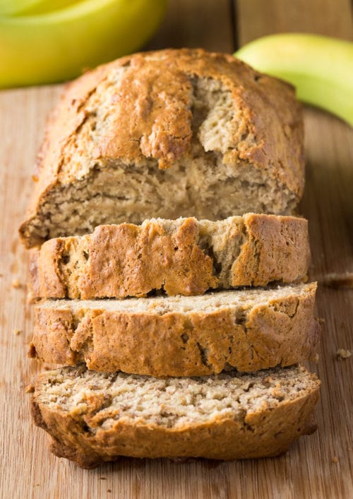 Fresh banana bread sitting on a cutting board.