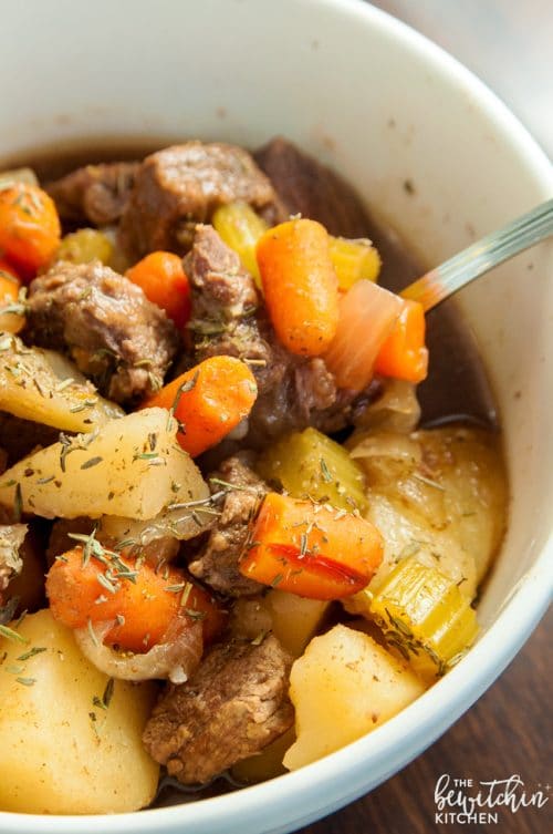 A bowl full of beef stew fresh out of the Crockpot.