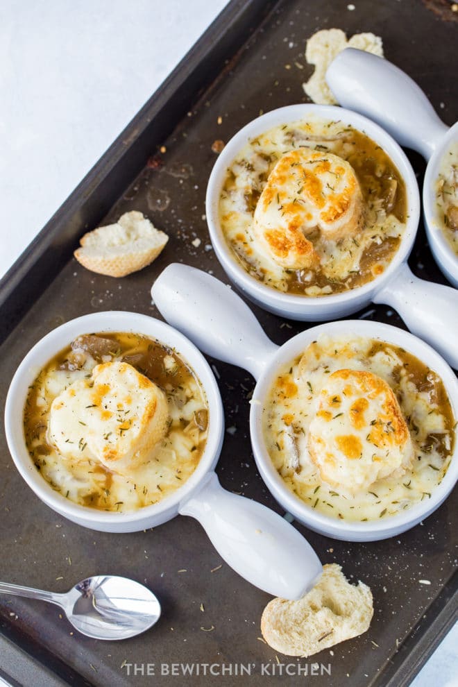 Overhead shot of crockpot french onion soup in bowls with melted cheese.