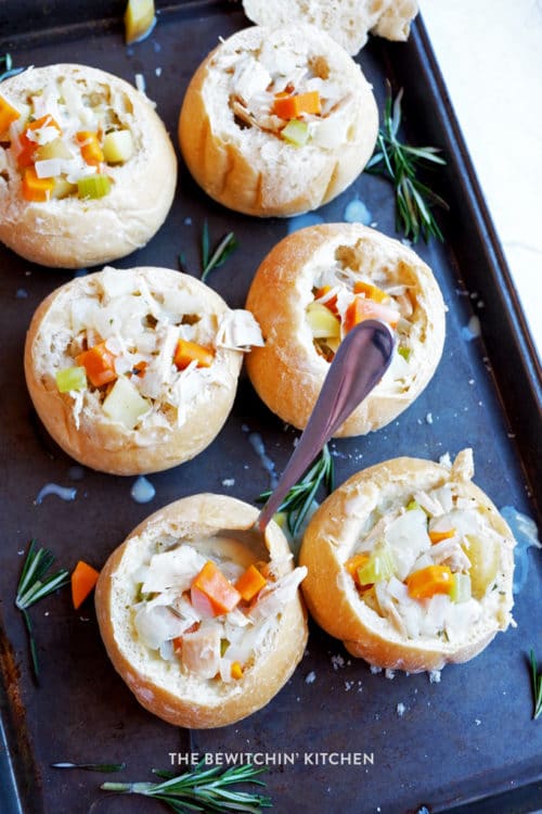 Over head look of 6 sourdough buns hollowed out and filled with a homemade, creamy, turkey soup