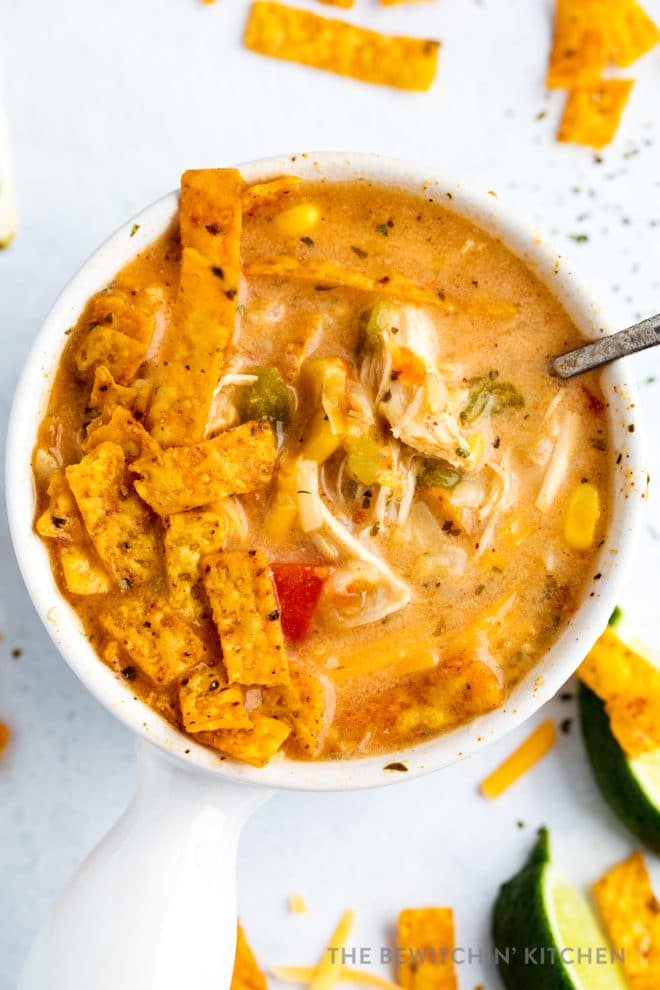 Overhead view of chicken tortilla soup mixed with greek yogurt and cheese.