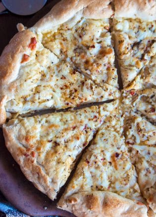 Italian Pizza Bread - this was my favorite appetizer recipe growing up! Soft pizza crust with zesty italian salad dressing, garlic, parmesan and mozzarella. Yum!