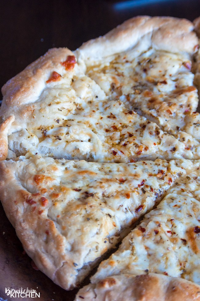 A side view of a thick crust, Italian Pizza Bread.