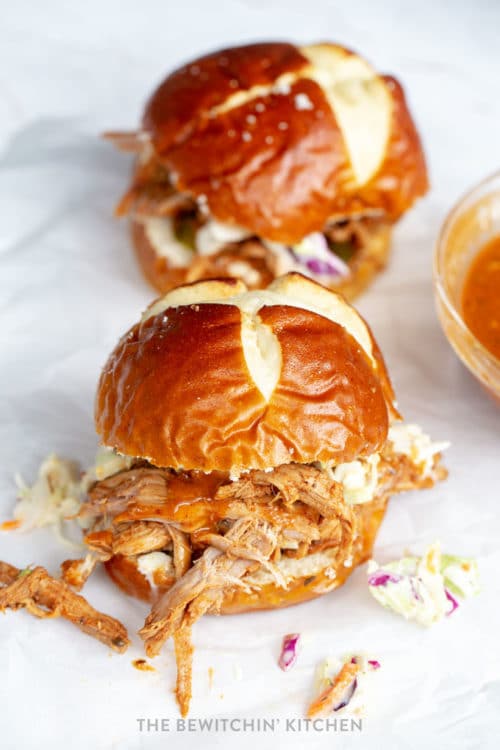 Pulled pork with homemade barbecue sauce stuffed inside a pretzel bun with homemade coleslaw.