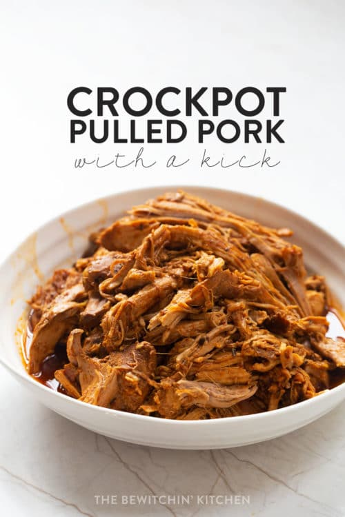 Pulled pork made in a slow cooker in a bowl with a white background