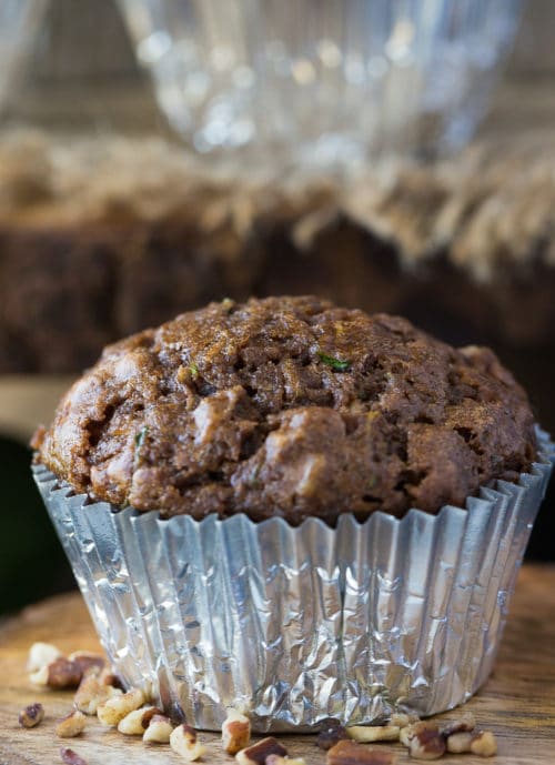 A tender chocolate muffin with zucchini in a cupcake liner.