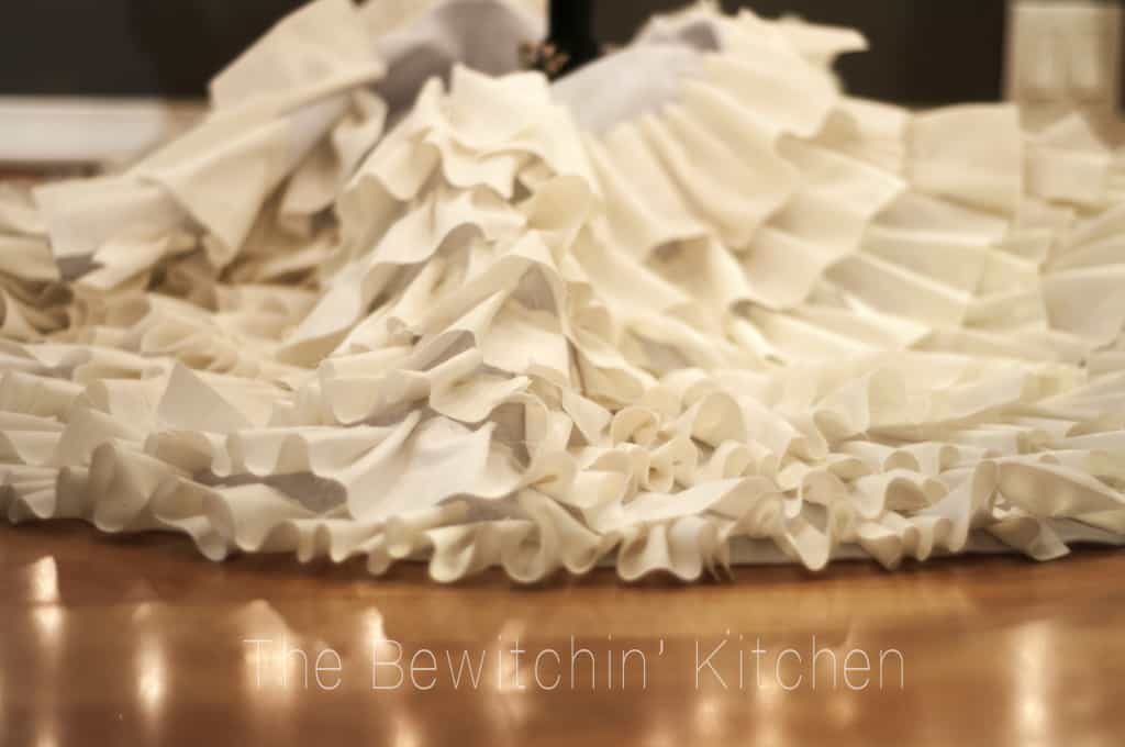 This DIY Ruffled tree skirt is such an easy craft. DIY Christmas crafts made simple are a great way to craft with the family! With this tutorial from The Bewitchin’ Kitchen homemade Christmas decorations are easier then you think (and it's no sew)!
