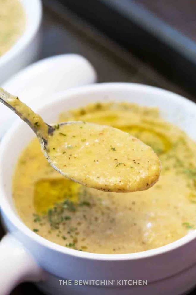 A spoon full of of roasted cauliflower soup