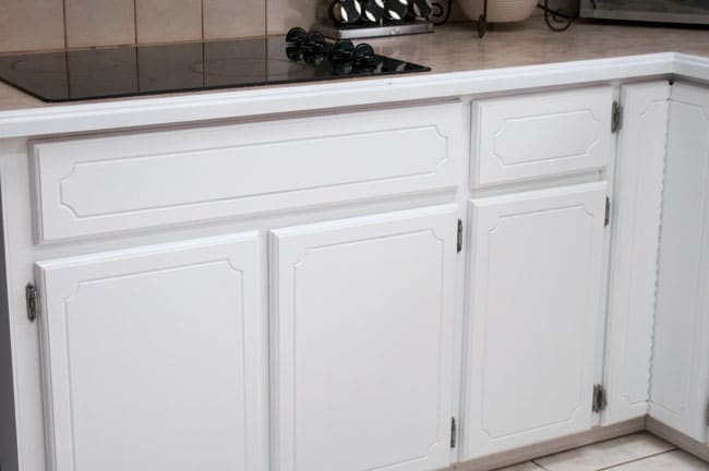 Transforming a 45 year old kitchen just by painting kitchen cabinets. This dated kitchen had old, oak cabinets that needed a little life. Products used: INSL-X Cabinet coat tinted in Benjamin Moore Chantilly Lace. Nothing like a little DIY renovation to spruce up kitchen cupboards..