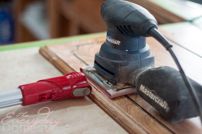 Helpful tip when sanding kitchen cabinets: hold the vacuum next to the sander. It helps reduce the dust.