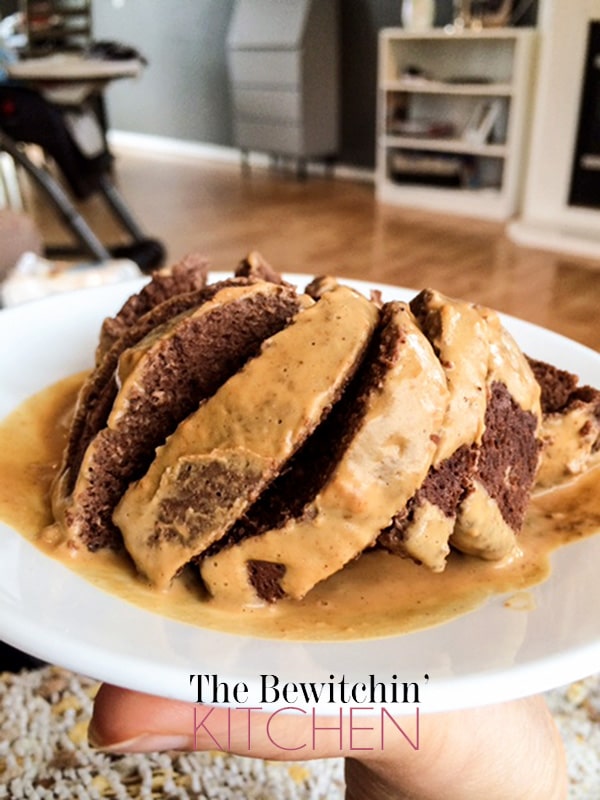 sliced protein mug cake with drizzle on white plate