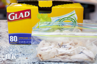 Weighing and bagging chicken from a roasted chicken for salads