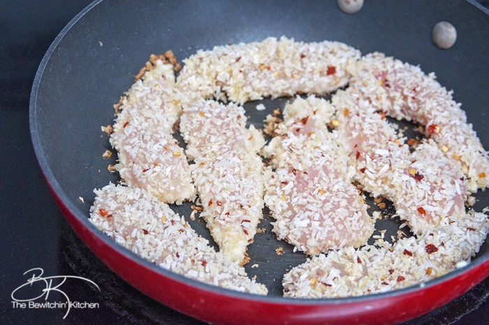 Coconut Crusted Chicken with Thai Chili Sauce. This coconut chicken recipe is an easy and fast meal. It's one of my favorite dinner recipes. | The Bewitchin' Kitchen