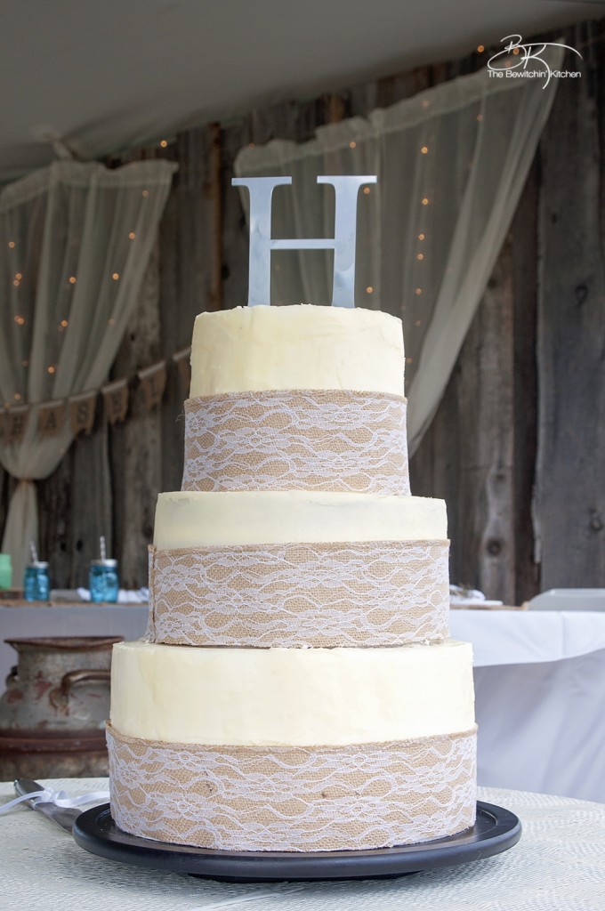 DIY wedding cake. This three tiered wedding cake is fake on the bottom and top, with two vanilla lemon cakes in the middle. Wrapped with a burlap and lace trim for a rustic wedding feel. Here's how I did it.