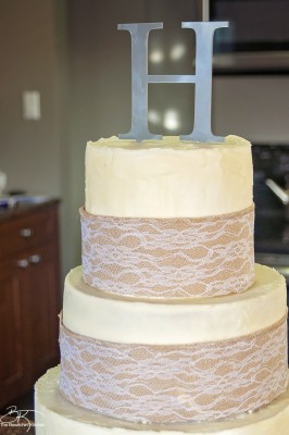 DIY wedding cake. This three tiered wedding cake is fake on the bottom and top, with two vanilla lemon cakes in the middle. Wrapped with a burlap and lace trim for a rustic wedding feel. Here's how I did it.
