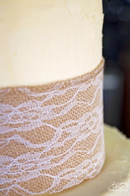 DIY wedding cake. This three tiered wedding cake is fake on the bottom and top, with two vanilla lemon cakes in the middle. Wrapped with a burlap and lace trim for a rustic wedding feel. Here's how I did it.