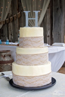 DIY wedding cake. This three tiered wedding cake is fake on the bottom and top, with two vanilla lemon cakes in the middle. Wrapped with a burlap and lace trim for a rustic wedding feel. Here's how I did it.