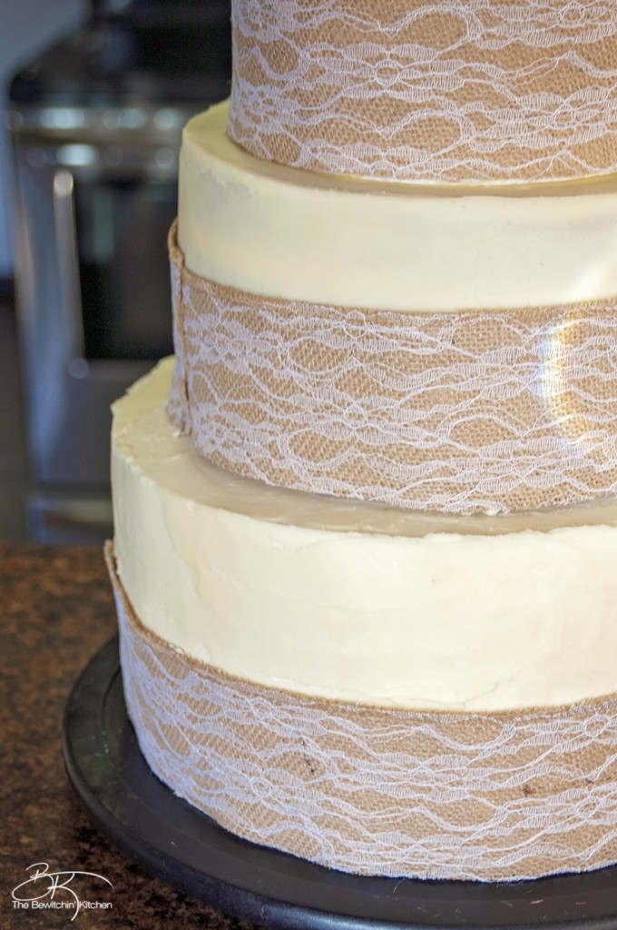 DIY wedding cake. This three tiered wedding cake is fake on the bottom and top, with two vanilla lemon cakes in the middle. Wrapped with a burlap and lace trim for a rustic wedding feel. Here's how I did it.