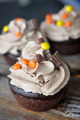 The PMS Buster - Chocolate Peanut Butter Filled Cupcakes with the world's best buttercream recipe: Chocolate Peanut Butter Frosting. Must try dessert recipe!