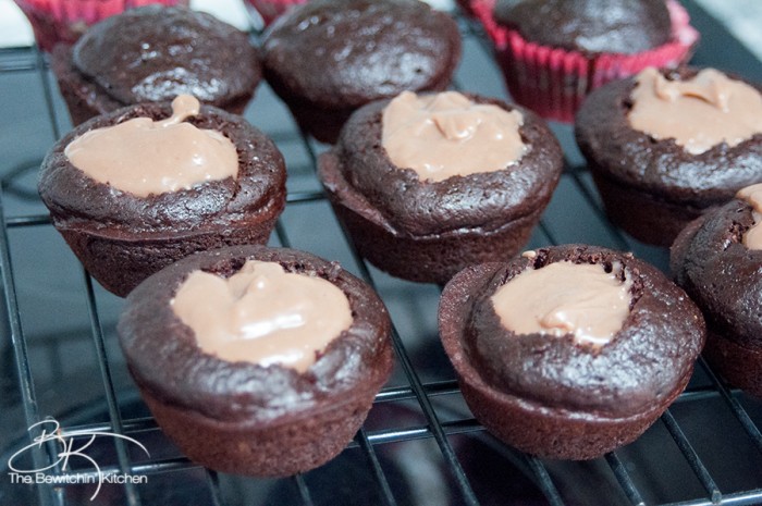 The PMS Buster - Chocolate Peanut Butter Filled Cupcakes with the world's best buttercream recipe: Chocolate Peanut Butter Frosting. Must try dessert recipe!