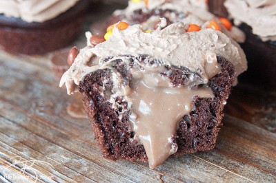 The PMS Buster - Chocolate Peanut Butter Filled Cupcakes with the world's best buttercream recipe: Chocolate Peanut Butter Frosting. Must try dessert recipe!