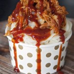 Well this is a fun play on food: Pulled Pork Sundae recipe. Whipped garlic potatoes, slow cooked pulled pork and tangy BBQ sauce. | The Bewitchin' Kitchen