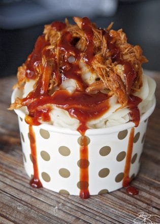 Well this is a fun play on food: Pulled Pork Sundae recipe. Whipped garlic potatoes, slow cooked pulled pork and tangy BBQ sauce. | The Bewitchin' Kitchen