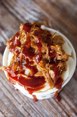 Well this is a fun play on food: Pulled Pork Sundae recipe. Whipped garlic potatoes, slow cooked pulled pork and tangy BBQ sauce. | The Bewitchin' Kitchen