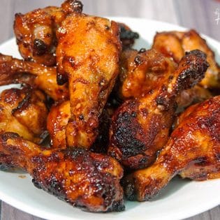 Sweet Sriracha Chicken Wings - this chicken wing recipe is the perfect blend of sweet and spicy. My husband asked me if he could go to the store, to buy more wings so I could make MORE of these tonight! Perfect for game day! | thebewitchinkitchen.com