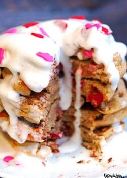 Gluten free pancakes smothered in a strawberry greek yogurt cream cheese sauce. This gluten free pancake recipe is so fluffy and yummy! A healthy breakfast packed with flavor. | thebewitchinkitchen.com