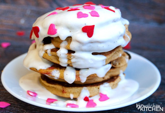 Gluten free pancakes smothered in a strawberry greek yogurt cream cheese sauce. This gluten free pancake recipe is so fluffy and yummy! A healthy breakfast packed with flavor. | thebewitchinkitchen.com