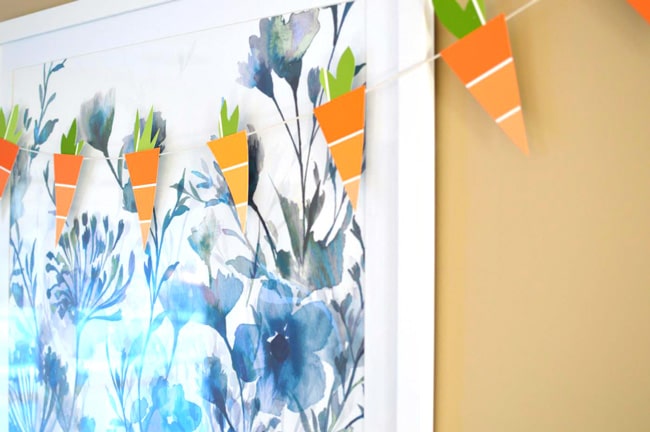 Paint Chip Spring Carrots. This Easter craft is so easy and cheap! Grab free paint chips from your local hardware store and string them up. It's an easy craft and a cute DIY! Gotta love easy paint chip crafts.