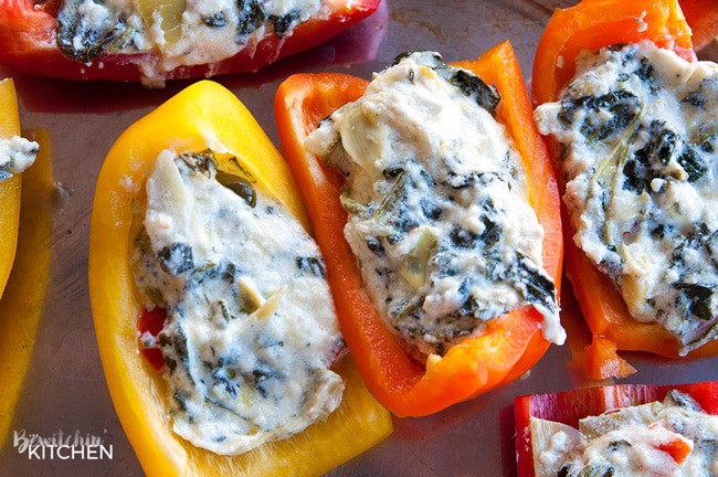 Spinach artichoke stuffed peppers wrapped in prosciutto. Add this to your appetizer recipes. Spinach dip, bell peppers, prosciutto - it sounds like heaven. It has a little kick from jalapenos too. The perfect party food recipe. | thebewitchinkitchen.com