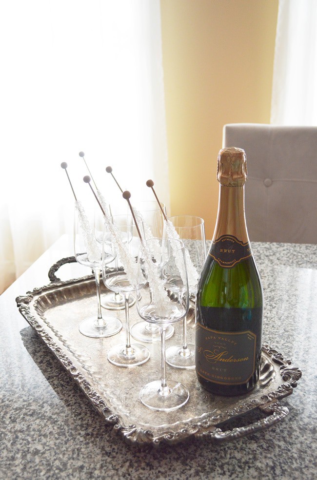 This champagne on the rocks idea is an elegant way to glam up your party (or Friday night). Perfect New Years Eve Party Idea. It's so easy too: sparkling wine and rock candy! An easy and low cost way to add class to your party.