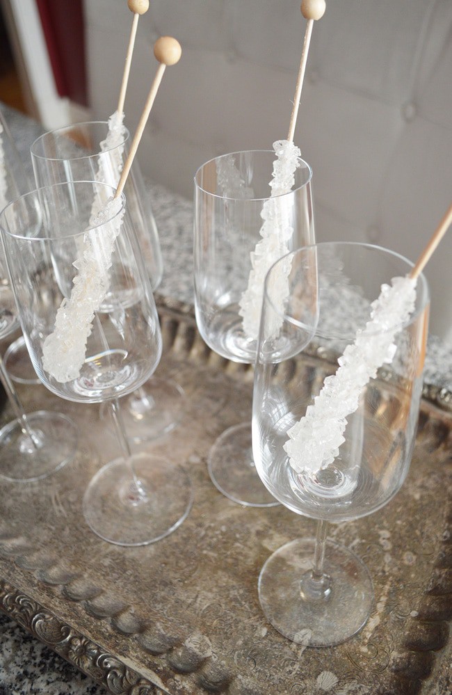 This champagne on the rocks idea is an elegant way to glam up your party (or Friday night). Perfect New Years Eve Party Idea. It's so easy too: sparkling wine and rock candy! An easy and low cost way to add class to your party.