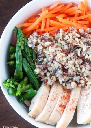 Spring Chicken Bowls with Honey Dijon Dressing - this healthy recipe makes the perfect lunch, snack or dinner. Loaded with roasted red pepper, grilled chicken breast, matchstick carrots, steamed asparagus, quinoa blend and topped with a healthy dressing. This recipe is 21 Day Fix approved. #chickendotca | thebewitchinkitchen.com