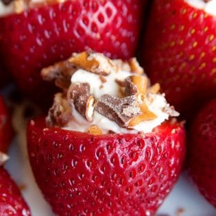 Rum Cheesecake Stuffed Strawberries. This easy, no bake dessert recipe is a party favorite. Cream cheese, sugar and rum extract, topped with crunchy milk chocolate covered pretzels makes this bite sized treat sweet, salty and crunchy. Add this to your popular desserts board.