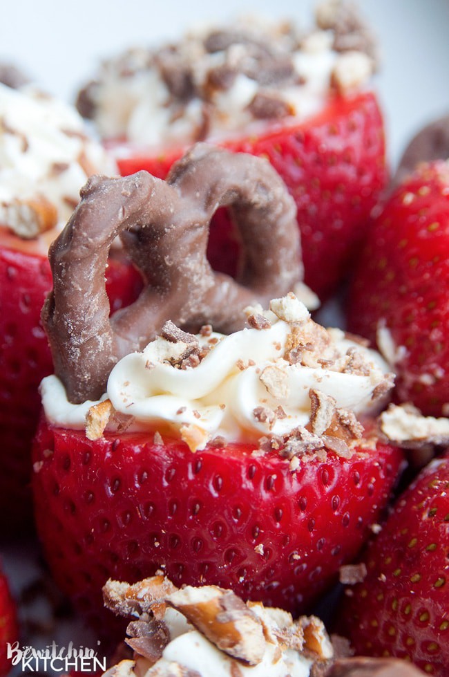 Cheesecake Stuffed Strawberries. This easy, no bake dessert recipe is a party favorite. Cream cheese, sugar and vanilla, topped with crunchy milk chocolate covered pretzels makes this bite sized treat sweet, salty and crunchy. Add this to your popular desserts board.