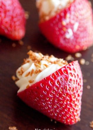 OMG Coconut Cheesecake Stuffed Strawberries! This dessert recipe is amazing! It's fast, easy and I love the crunch to the toasted coconut. Must make these for upcoming bridal showers and baby showers. Delicious party dessert idea!