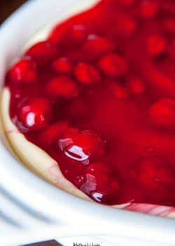 This easy cherry cheesecake recipe is the perfect summer dessert. Using a sugar cookie crust, a no bake cheesecake recipe and cherry pie filling it's a delicious dessert for summer bbqs without the work! | thebewitchinkitchen.com