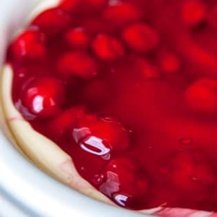 This easy cherry cheesecake recipe is the perfect summer dessert. Using a sugar cookie crust, a no bake cheesecake recipe and cherry pie filling it's a delicious dessert for summer bbqs without the work! | thebewitchinkitchen.com