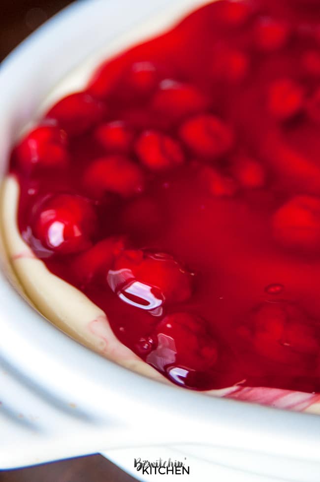 This easy cherry cheesecake recipe is the perfect summer dessert. Using a sugar cookie crust, a no bake cheesecake recipe and cherry pie filling it's a delicious dessert for summer bbqs without the work! | thebewitchinkitchen.com