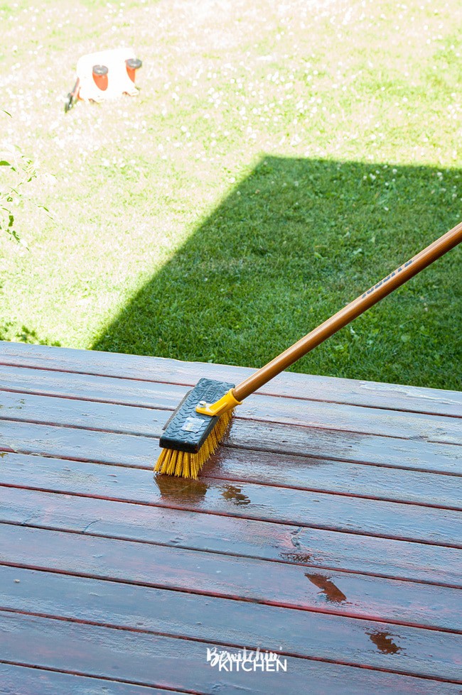 How to stain a deck in 4 easy steps. This DIY deck renovation uses Behr's Premium Deck Stripper, Wood Cleaner and Semi-Transparent Stain in Redwood Naturaltone. The before and after looks incredible!