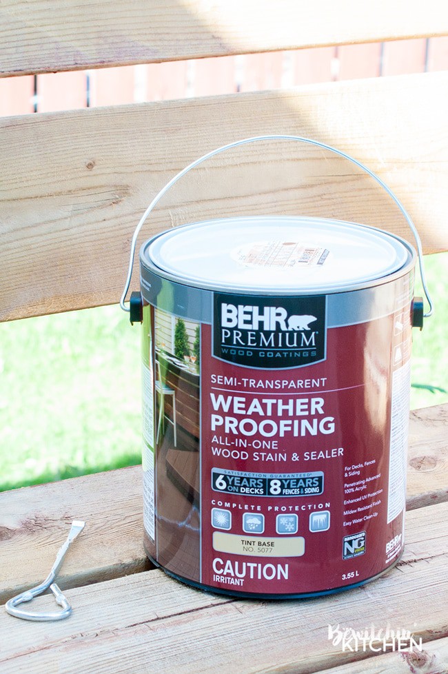 How to stain a deck in 4 easy steps. This DIY deck renovation uses Behr's Premium Deck Stripper, Wood Cleaner and Semi-Transparent Stain in Redwood Naturaltone. The before and after looks incredible!