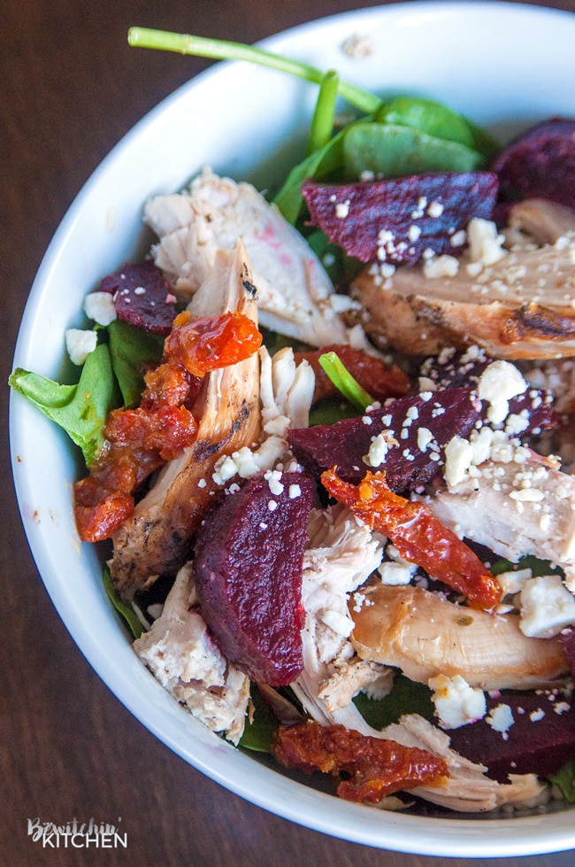 This salad is so good: baby spinach, grilled chicken, feta, sundried tomatoes, and beets. All tossed in a Pesto Vinaigrette. A delicious lunch or dinner recipe that's 21 Day Fix approved.