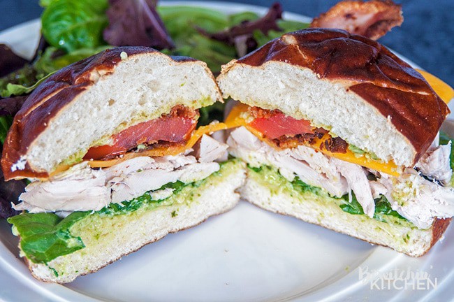 Chicken Club Pretzel Bun Sandwich - This sandwich recipe was inspired by Swiss Chalet's Chicken Club Kaiser. This is perfect for lunch, dinner or a snack and I LOVE the pesto mayo. It's an easy recipe to make if you have some pre-cooked chicken ready to go, perfect for leftovers with a twist.