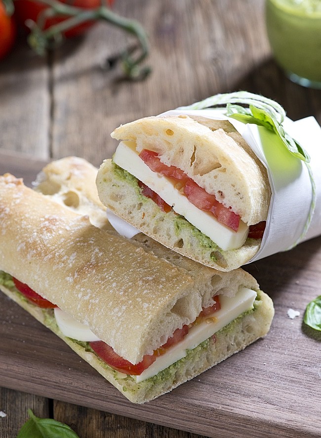 Garden Pesto Tomato Mozza Sandwich. This sandwich recipe is perfect for lunch, dinner or a snack. Using fresh tomatoes, pesto and mozzarella cheese this sandwich is a summer favorite.